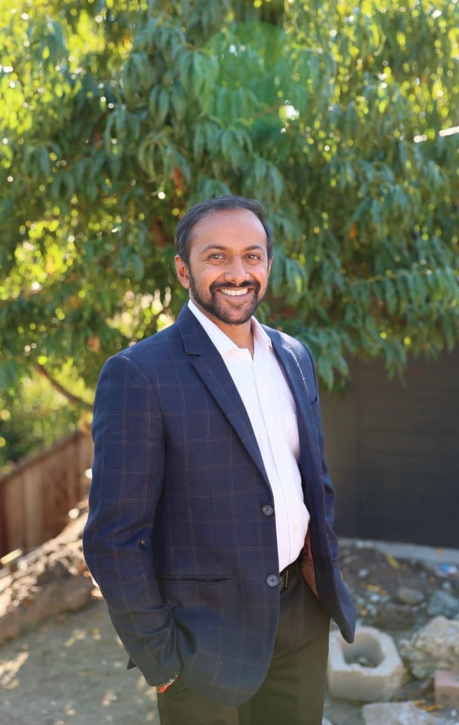 Dr. Serah Uddaraju smiling outdoors in a navy blazer